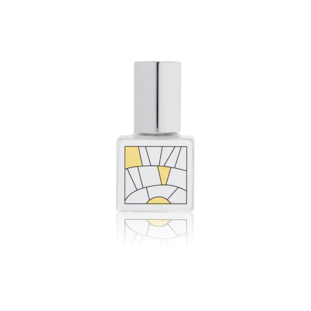 Kelly & Jones "CITRUS" perfume bottle: small, clear, square bottle with a long chrome lid top. Minimalistic design graphic with yellow.