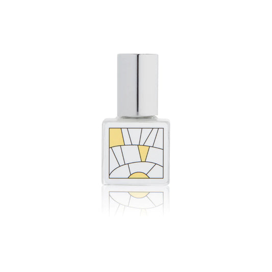 Kelly & Jones "CITRUS" perfume bottle: small, clear, square bottle with a long chrome lid top. Minimalistic design graphic with yellow.