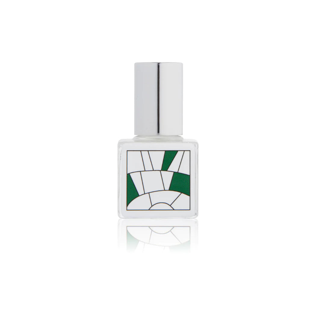 Kelly & Jones "EARTH" perfume bottle: small, clear, square bottle with a long chrome lid top. Minimalistic design graphic with green.