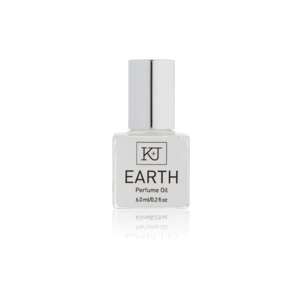 Kelly & Jones "EARTH" perfume bottle: small, clear, square bottle with a long chrome lid top. Text reads "EARTH Perfume Oil 6.0ml/0.2 fl oz"