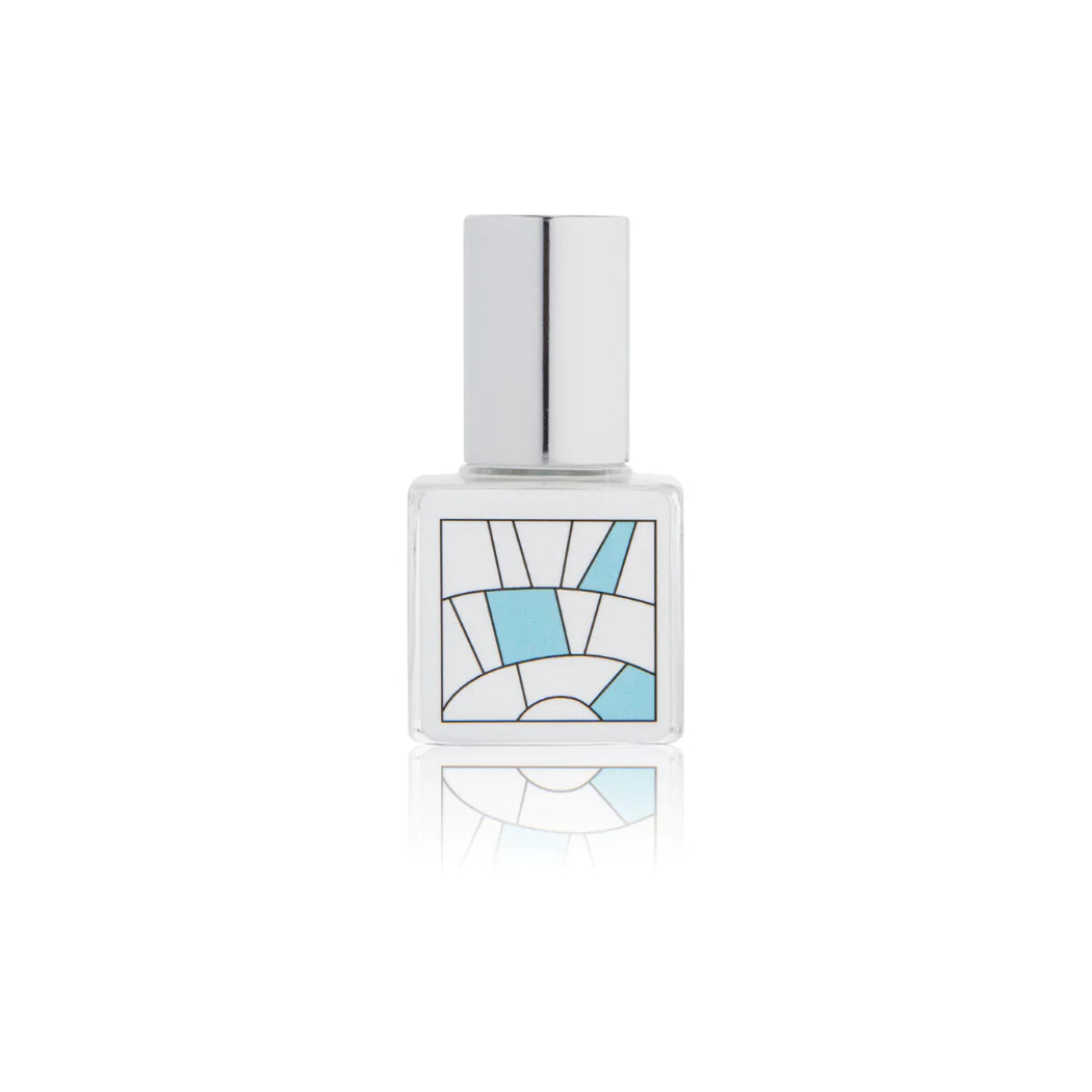 Kelly & Jones "FLORAL" perfume bottle: small, clear, square bottle with a long chrome lid top. Minimalistic design with blue.