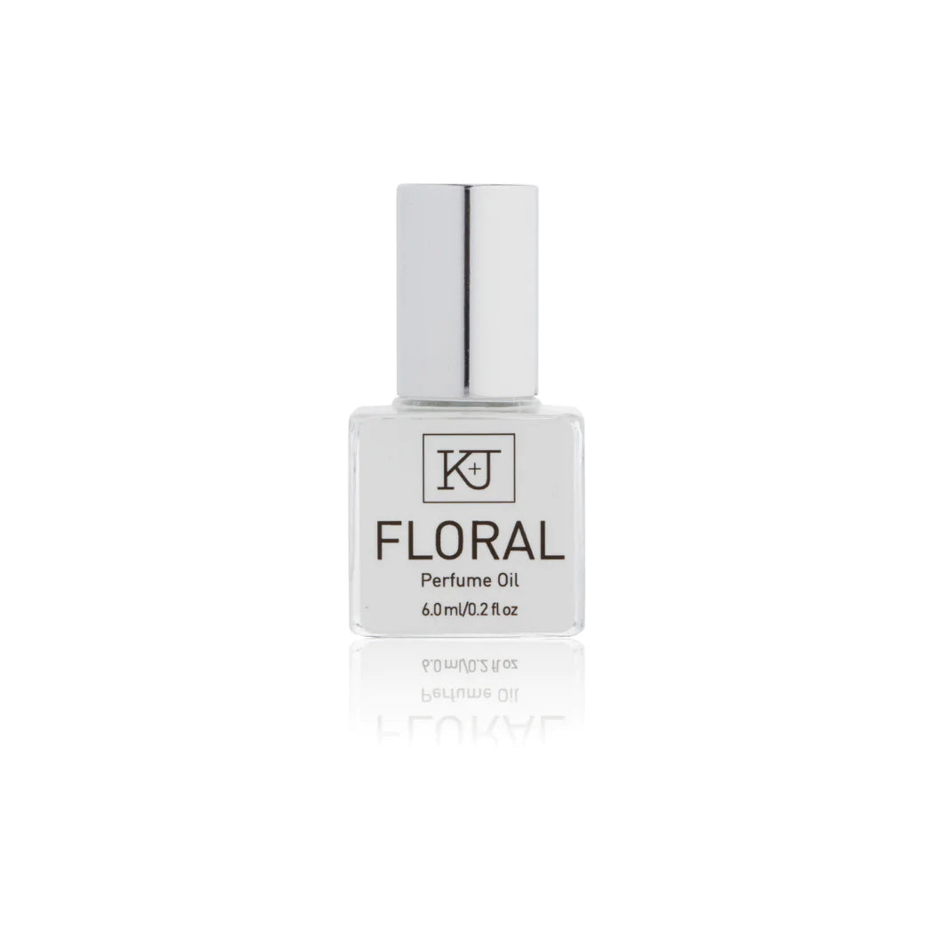 Kelly & Jones "FLORAL" perfume bottle: small, clear, square bottle with a long chrome lid top. Text reads "FLORAL Perfume Oil 6.0ml/0.2 fl oz"