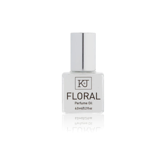 Kelly & Jones "FLORAL" perfume bottle: small, clear, square bottle with a long chrome lid top. Text reads "FLORAL Perfume Oil 6.0ml/0.2 fl oz"