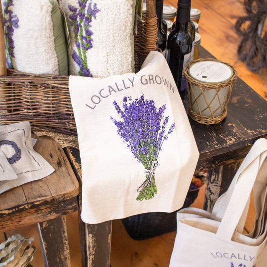 "Locally Grown" Lavender Tea Towel displayed on our lavender product table.