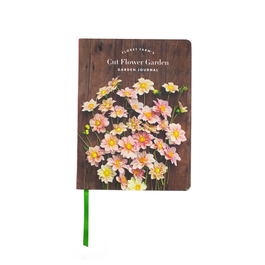 Floret Farm's Cut Flower Garden, Garden Journal. Softcover with white and pink flowers on a rustic wooden background as the cover. Comes with a green ribbon book mark.
