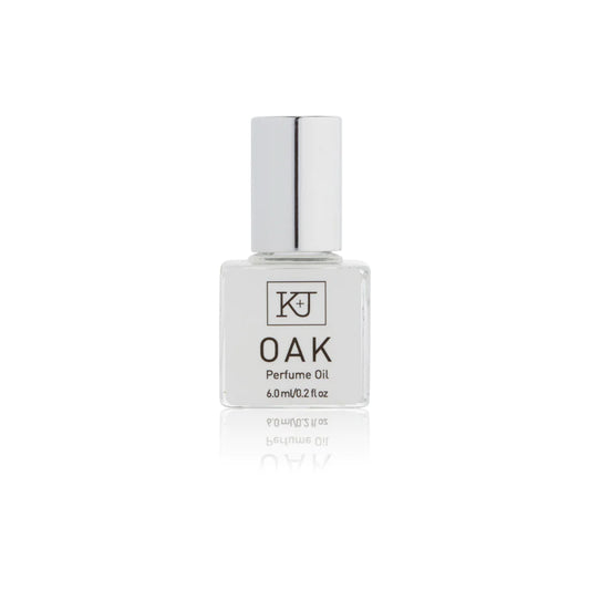 Kelly & Jones "OAK" perfume bottle: small, clear, square bottle with a long chrome lid top. Text reads "OAK Perfume Oil 6.0ml/0.2 fl oz"