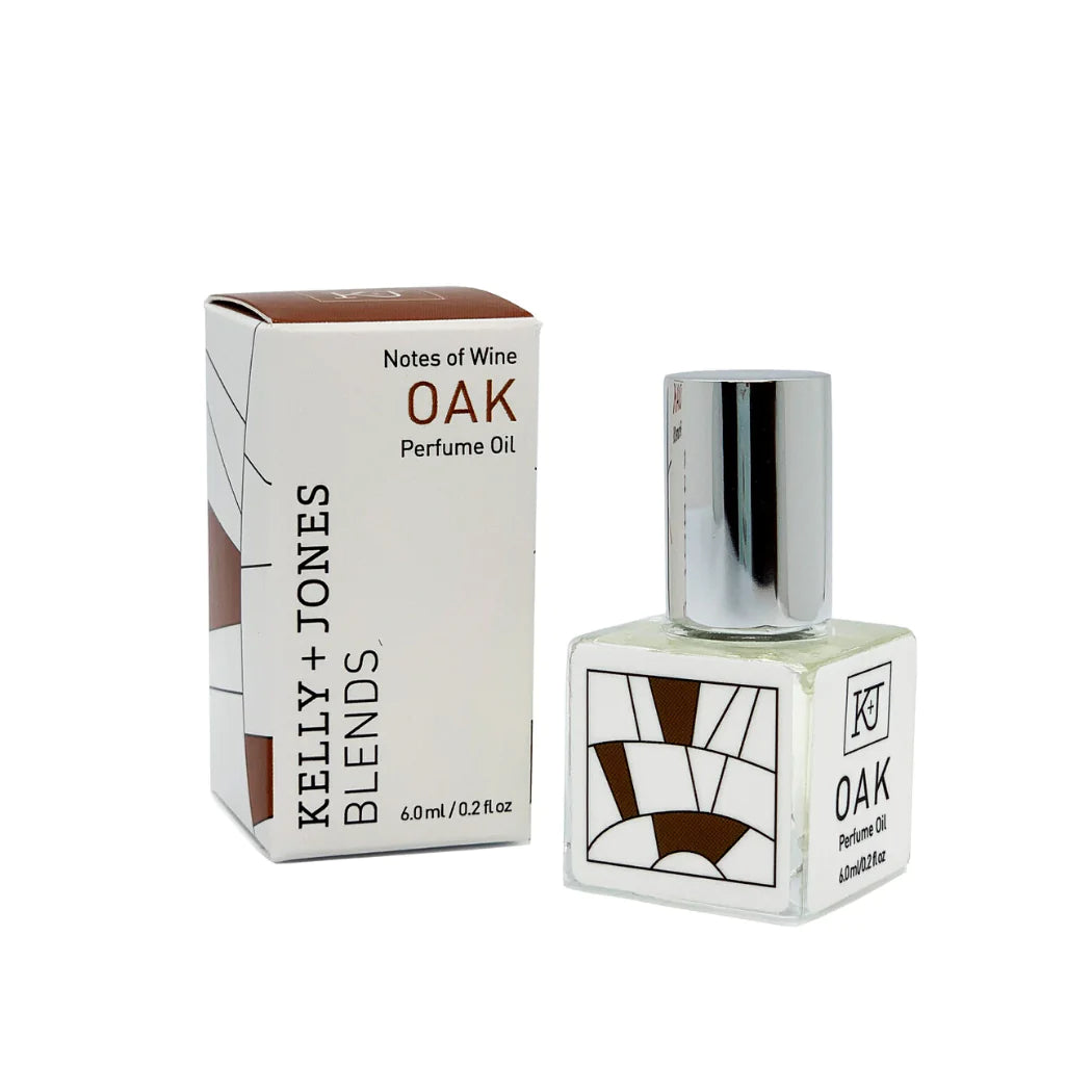 Kelly & Jones "OAK" perfume bottle: small, clear, square bottle with a long chrome lid top. Text reads "OAK Perfume Oil 6.0ml/0.2 fl oz" with a minimalistic design. Comes with small box.